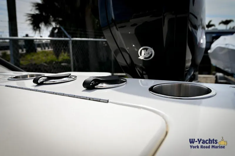 Slide: The Image of 2024 Bayliner T20 boat deck with cup holders and Mercury outboard motor. - 25