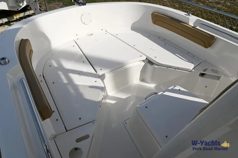Slide: The Image of 2024 Bayliner T20 boat interior with white seating and storage compartments. - 5