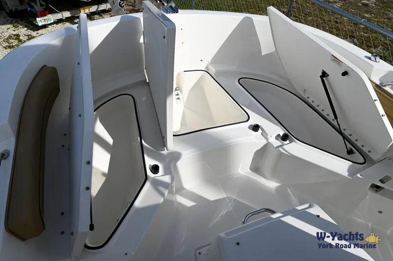 Slide: The Image of 2024 Bayliner T20 boat interior with open storage compartments. - 6