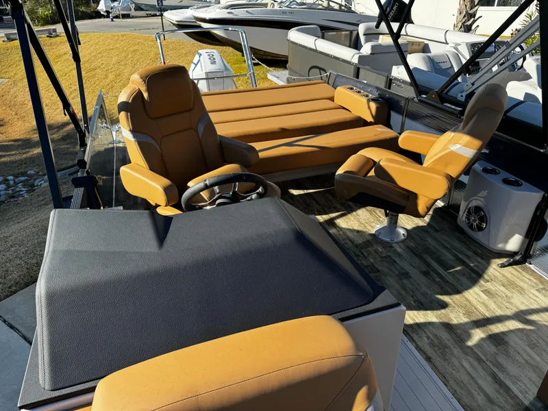 Slide: The Image of 2024 Crest Caribbean LX 230 boat interior with tan seating and steering console. - 11