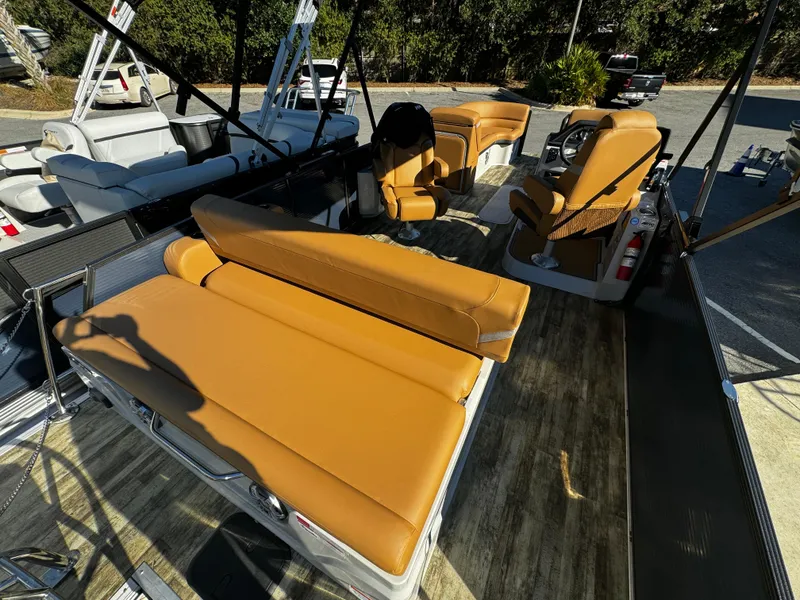 Slide: The Image of 2024 Crest Caribbean LX 230 boat with tan leather seats and spacious deck. - 8