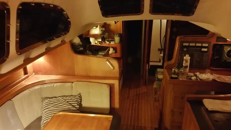 Slide: The Image of Interior of a 1967 Columbia Yacht 50 with wooden furnishings and cozy seating area. - 11
