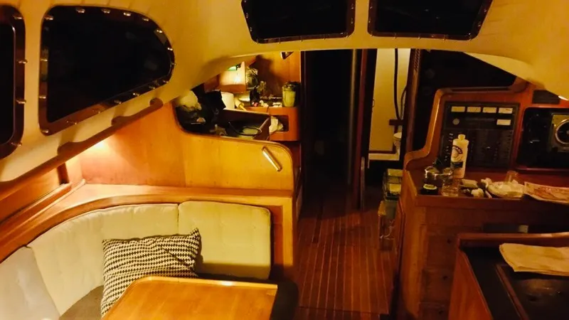 Slide: The Image of Interior of a 1967 Columbia Yacht 50, featuring cozy seating and wooden finishes. - 14