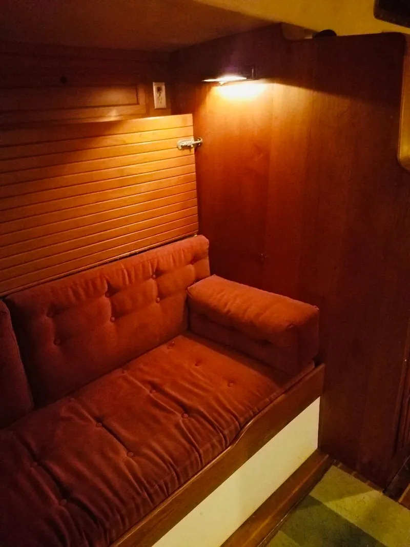 Slide: The Image of Interior of 1967 Columbia Yacht 50 with red cushioned seating. - 20
