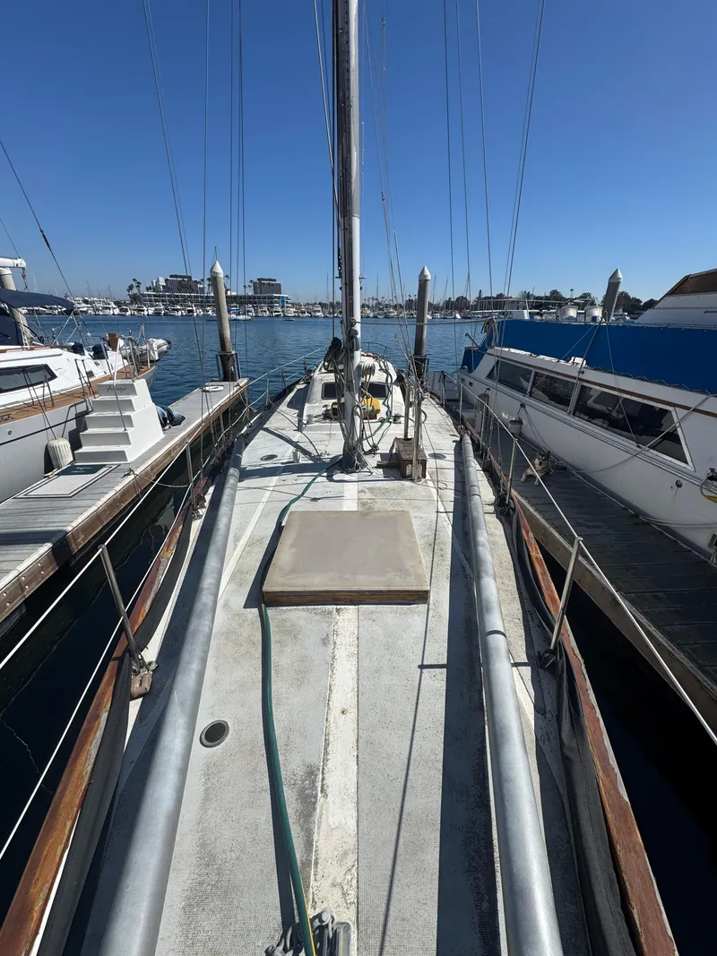Slide: The Image of 1967 Columbia Yacht 50 docked at marina, clear sky, calm waters. - 23