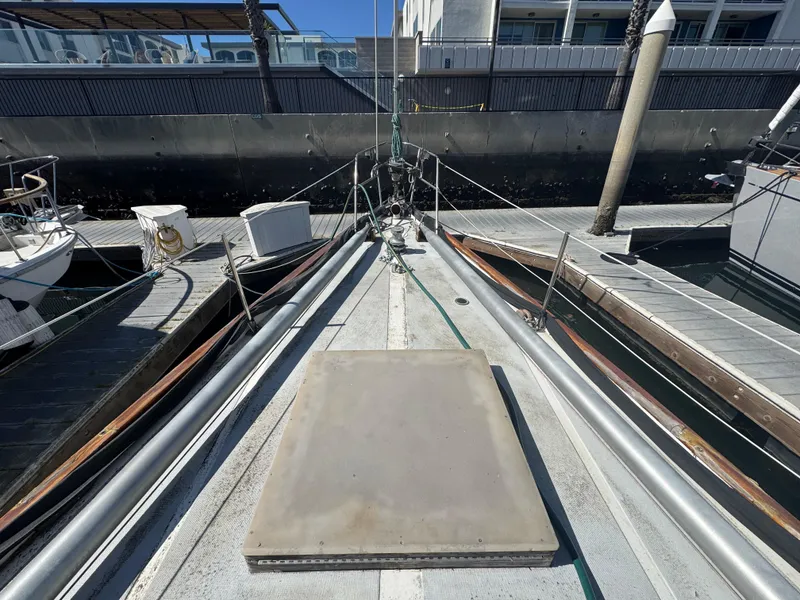 Slide: The Image of 1967 Columbia Yacht 50 docked, showing deck and marina surroundings. - 24