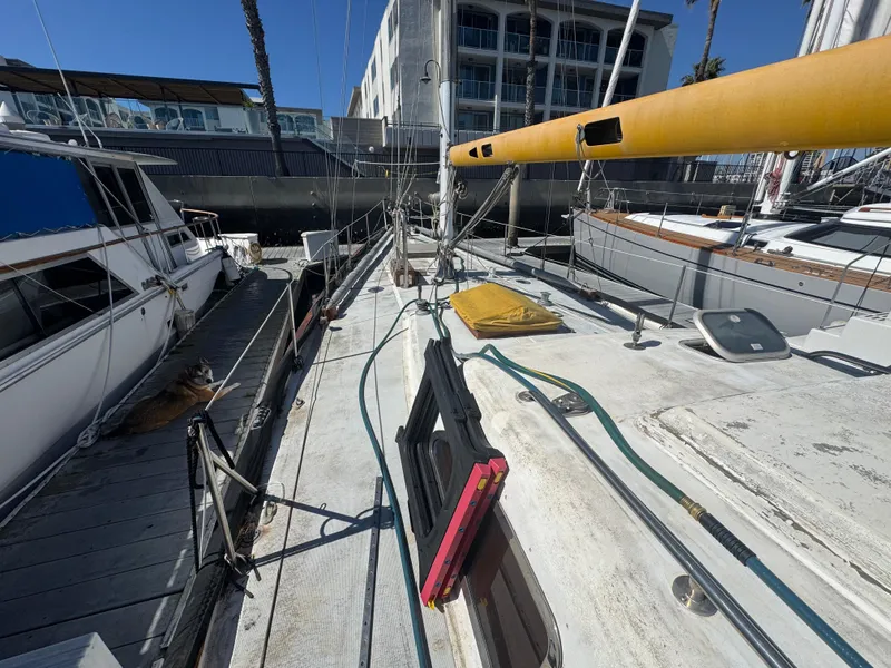 Slide: The Image of 1967 Columbia Yacht 50 docked, showcasing deck and mast in marina setting. - 25