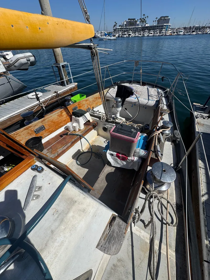 Slide: The Image of 1967 Columbia Yacht 50 docked, showcasing deck and cockpit area on a sunny day. - 27