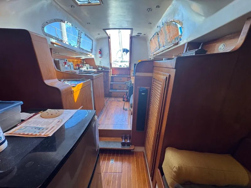 Slide: The Image of Interior of a 1967 Columbia Yacht 50, featuring wooden cabinetry and seating. - 28