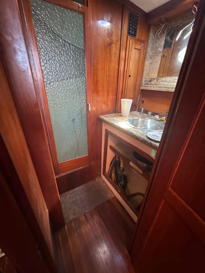 Slide: The Image of Interior of 1967 Columbia Yacht 50 with wooden cabinetry and compact sink area. - 29