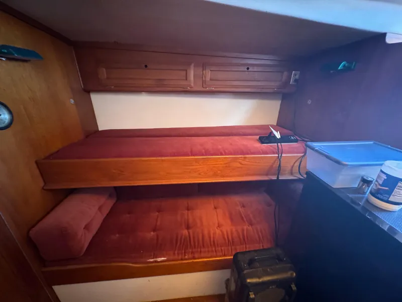 Slide: The Image of Interior of a 1967 Columbia Yacht 50 with red cushioned bunk beds. - 30