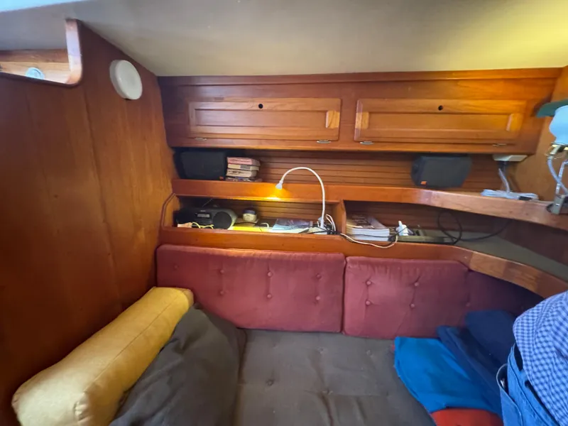 Slide: The Image of Cozy interior of a 1967 Columbia Yacht 50 with wooden cabinetry and cushioned seating. - 32