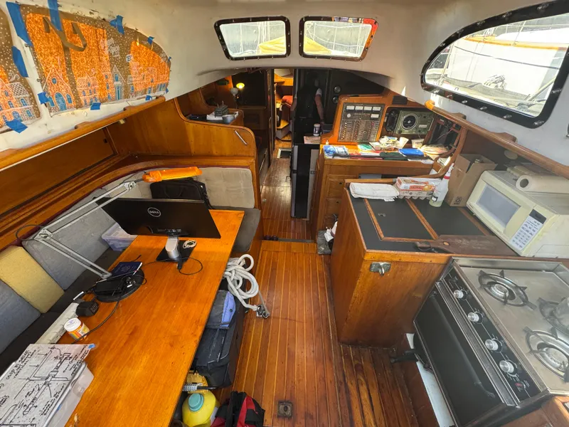 Slide: The Image of Interior of a 1967 Columbia Yacht 50 with wooden furnishings and modern amenities. - 33
