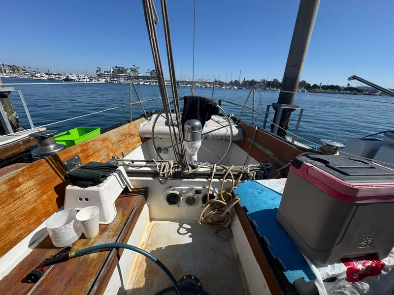 Slide: The Image of 1967 Columbia Yacht 50 cockpit with marina view, featuring nautical equipment and supplies. - 35