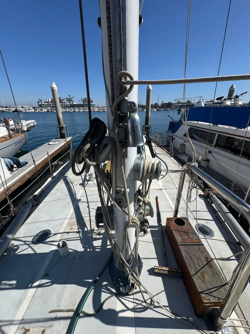 Slide: The Image of 1967 Columbia Yacht 50 docked, showcasing deck and rigging under clear blue sky. - 36