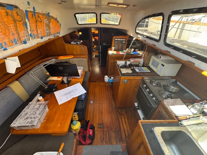 Slide: The Image of Interior of a 1967 Columbia Yacht 50 with kitchen and navigation area. - 4
