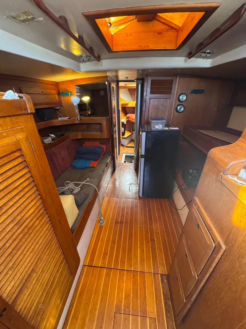 Slide: The Image of Interior of a 1967 Columbia Yacht 50, featuring wooden finishes and cozy living space. - 41