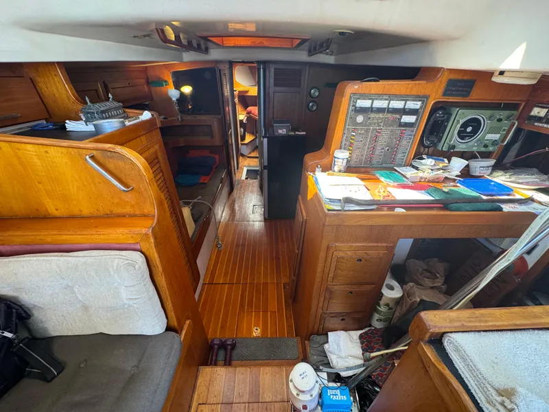 Slide: The Image of Interior of a 1967 Columbia Yacht 50, featuring wooden cabinetry and navigation equipment. - 42