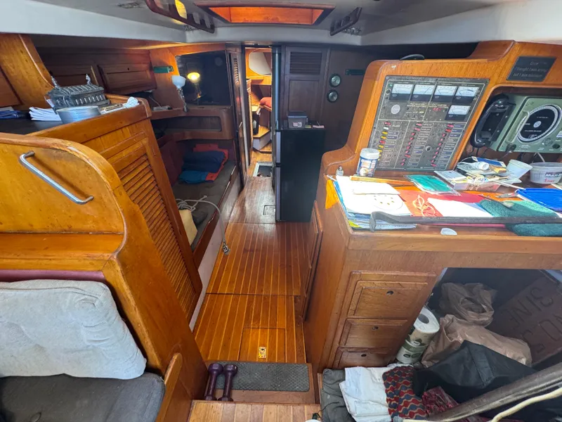 Slide: The Image of Interior of a 1967 Columbia Yacht 50, featuring wooden cabinetry and navigation equipment. - 43