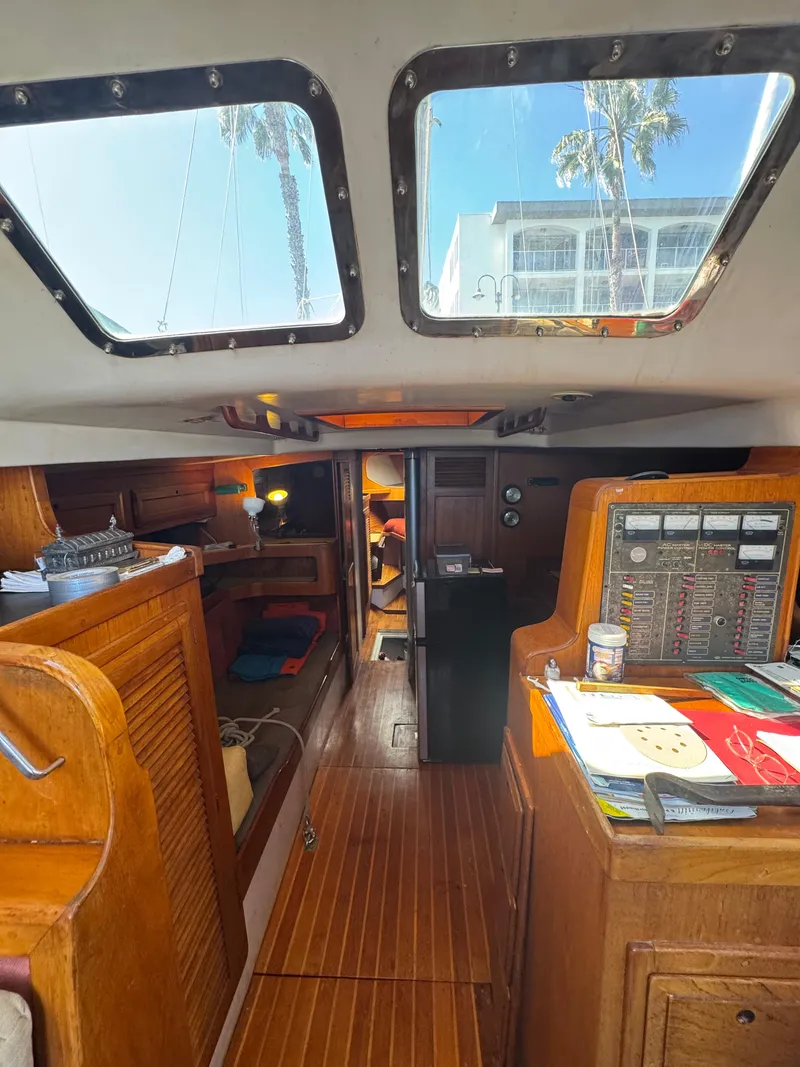 Slide: The Image of Interior of a 1967 Columbia Yacht 50, featuring wooden finishes and a navigation station. - 44