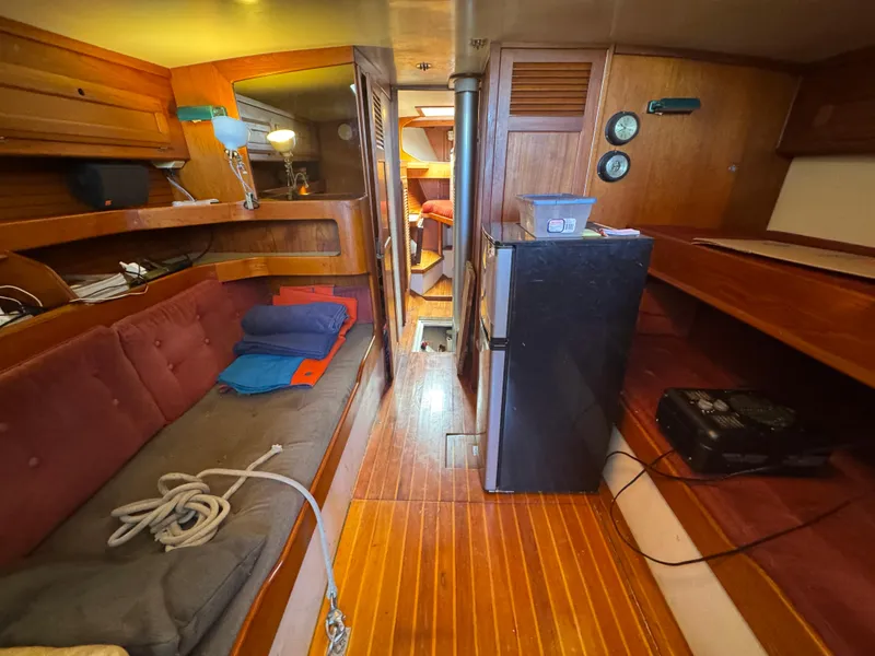 Slide: The Image of Interior of 1967 Columbia Yacht 50, featuring wood paneling and cozy seating area. - 45