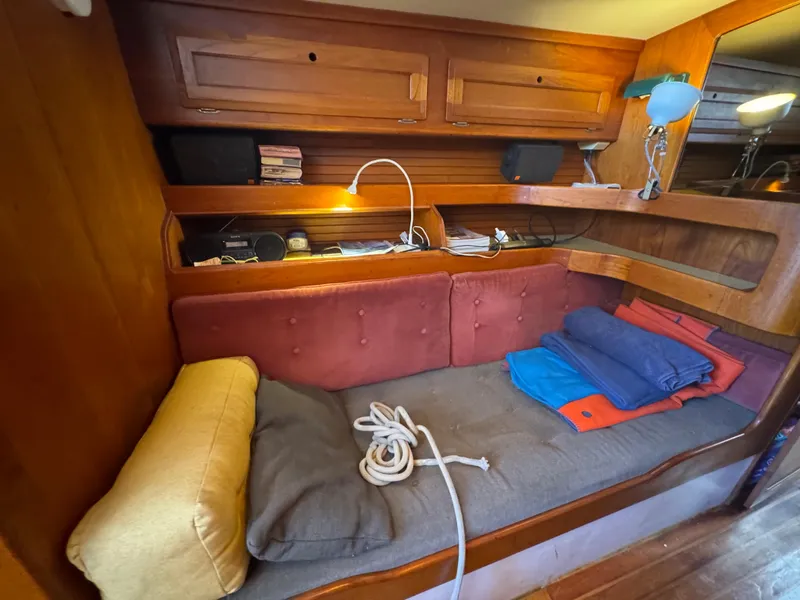 Slide: The Image of Cozy interior of 1967 Columbia Yacht 50 with wooden cabinetry and cushioned seating. - 46