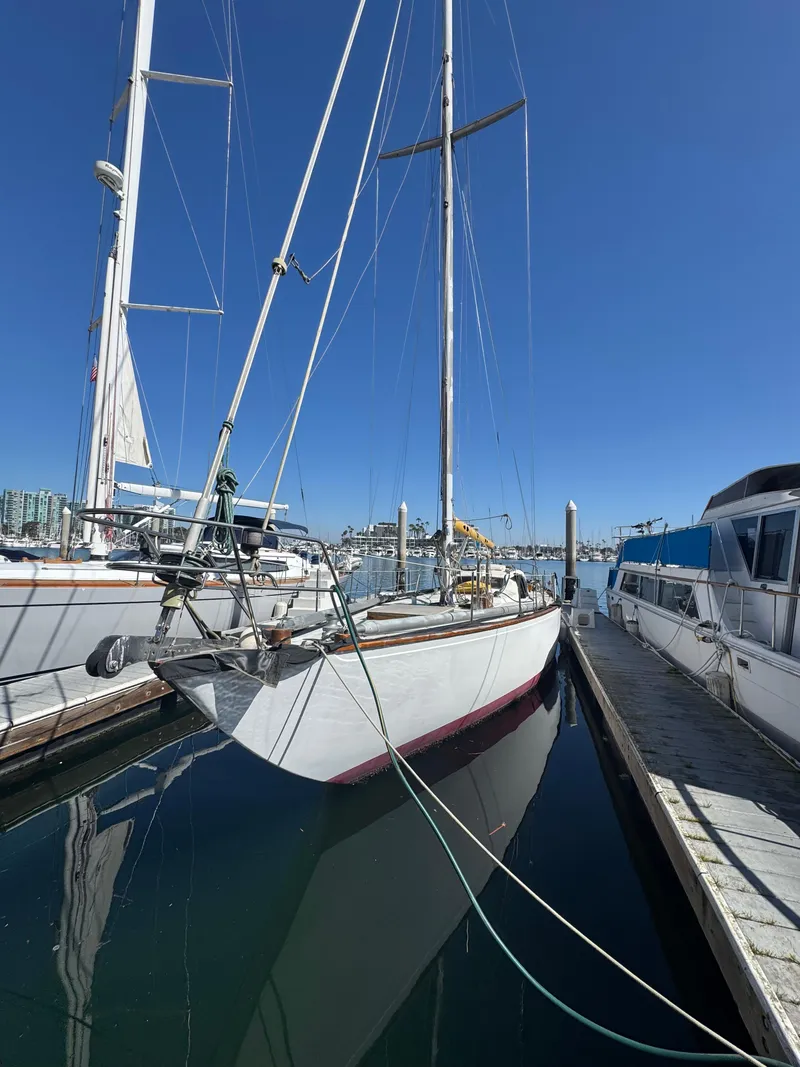 Slide: The Image of 1967 Columbia Yacht 50 docked in a marina under clear blue skies. - 48