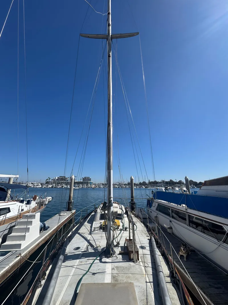 Slide: The Image of 1967 Columbia Yacht 50 docked at marina under clear blue sky. - 5
