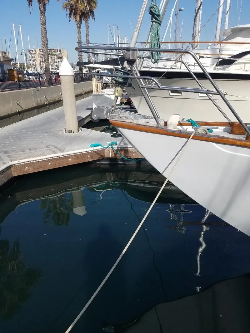Slide: The Image of 1967 Columbia Yacht 50 docked at a marina with clear blue water. - 9