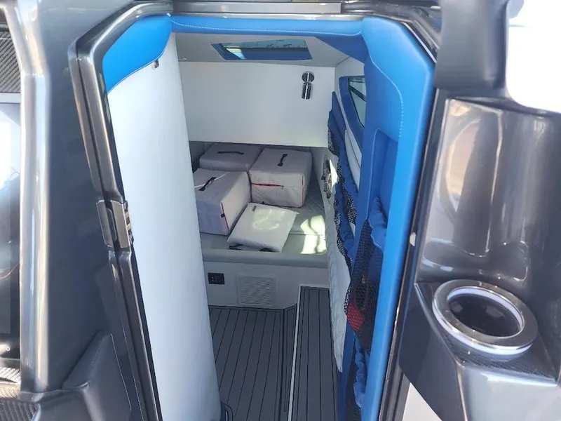 Slide: The Image of Interior cabin of 2024 Nor-Tech 400 Supersport boat with blue and white accents. - 11