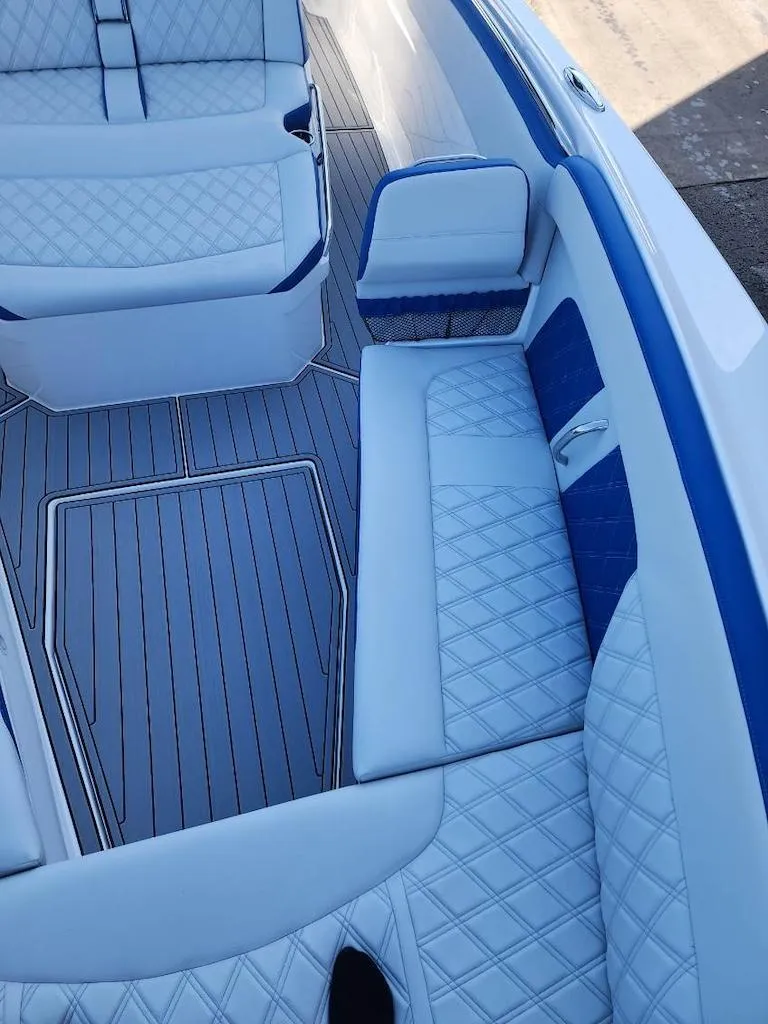 Slide: The Image of 2024 Nor-Tech 400 Supersport boat interior with white and blue diamond-stitched seating. - 12
