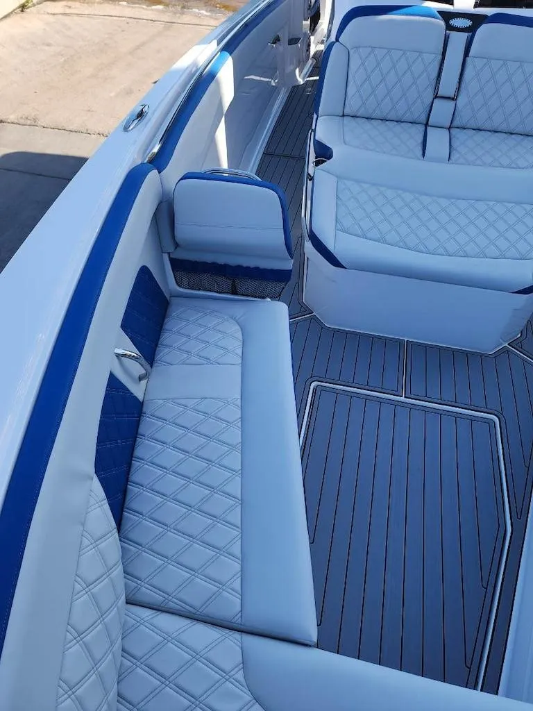 Slide: The Image of 2024 Nor-Tech 400 Supersport boat interior with white and blue seating. - 14