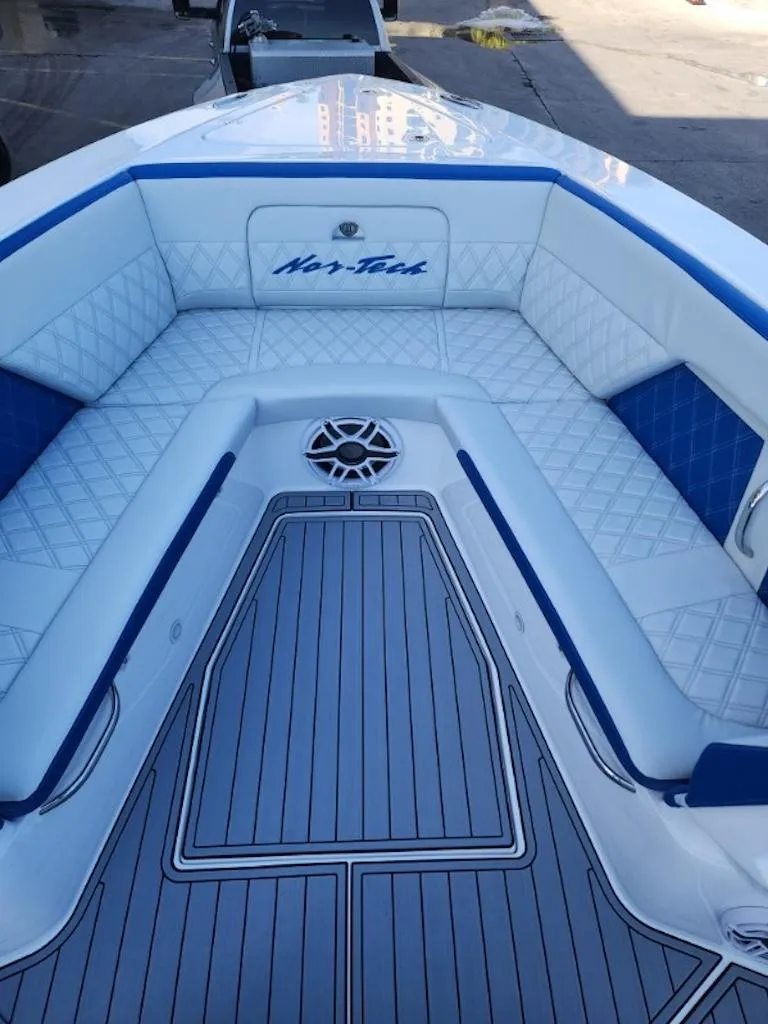 Slide: The Image of 2024 Nor-Tech 400 Supersport boat with luxurious white and blue seating. - 16
