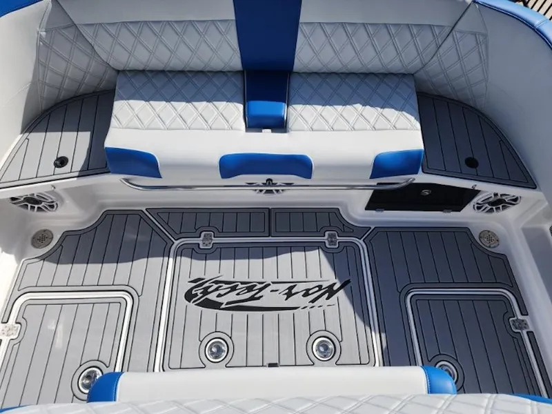 Slide: The Image of 2024 Nor-Tech 400 Supersport boat interior with blue and gray seating and flooring. - 17