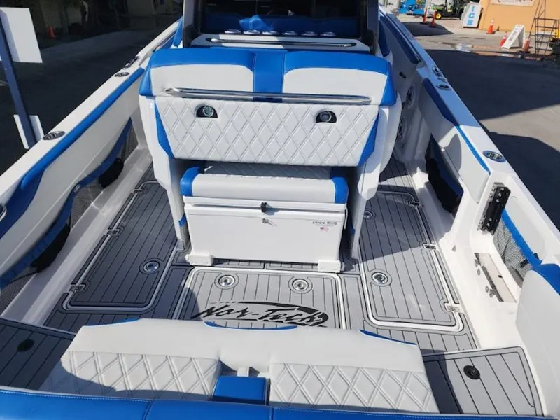 Slide: The Image of 2024 Nor-Tech 400 Supersport boat interior with blue and white seating. - 18