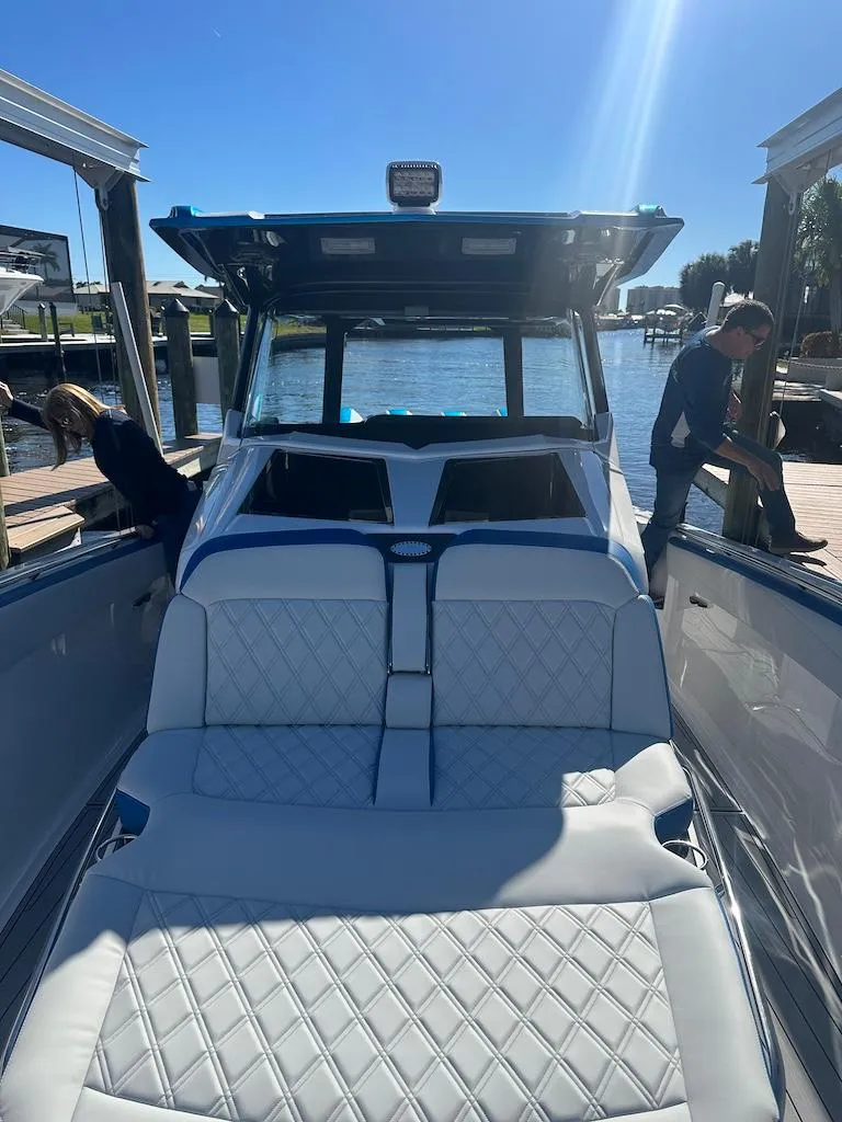 Slide: The Image of 2024 Nor-Tech 400 Supersport luxury boat with white quilted seating. - 24