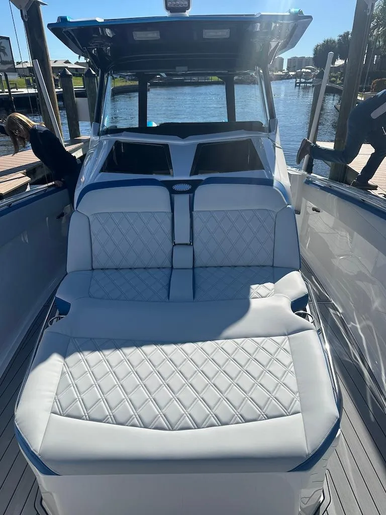 Slide: The Image of 2024 Nor-Tech 400 Supersport luxury boat with white quilted seating. - 25