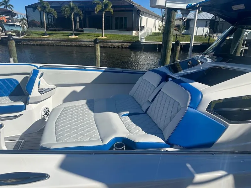 Slide: The Image of 2024 Nor-Tech 400 Supersport boat interior with luxurious seating by the water. - 27