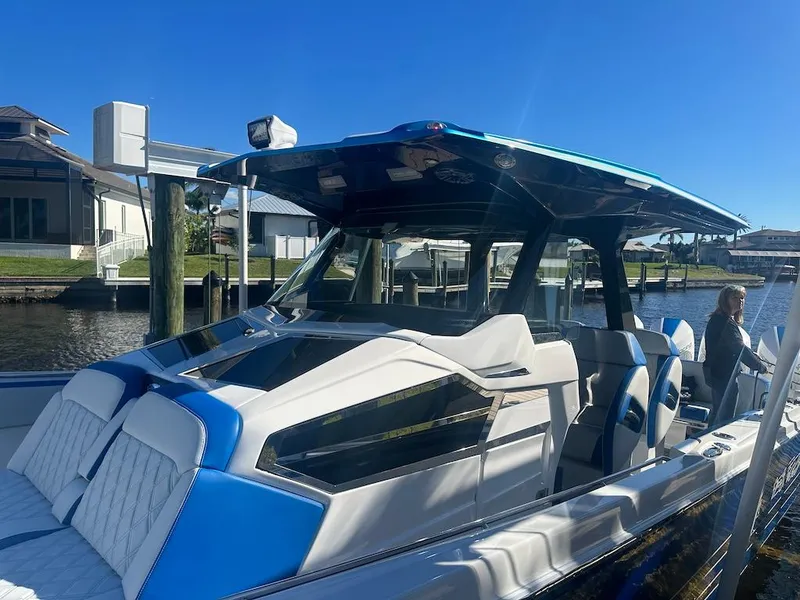 Slide: The Image of 2024 Nor-Tech 400 Supersport boat docked on a sunny day. - 28