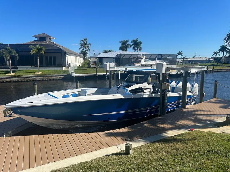 Slide: The Image of 2024 Nor-Tech 400 Supersport boat docked by waterfront homes. - 33