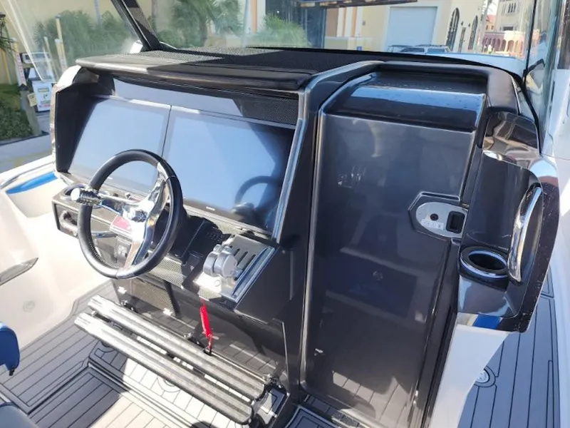 Slide: The Image of 2024 Nor-Tech 400 Supersport boat dashboard with steering wheel and control panel. - 8