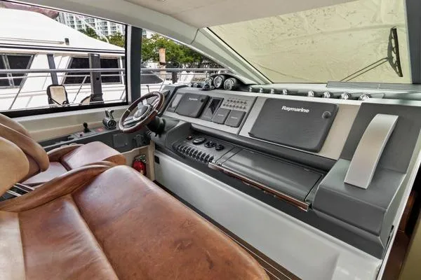 Slide: The Image of 2009 Azimut 68S yacht helm with leather seats and advanced navigation controls. - 7