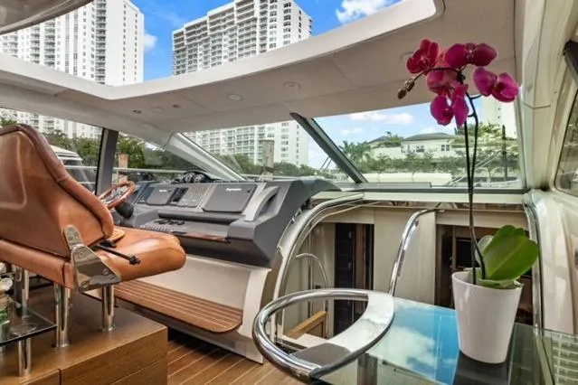 Slide: The Image of Luxurious 2009 Azimut 68S yacht interior with modern helm, leather seating, and vibrant orchid. - 8