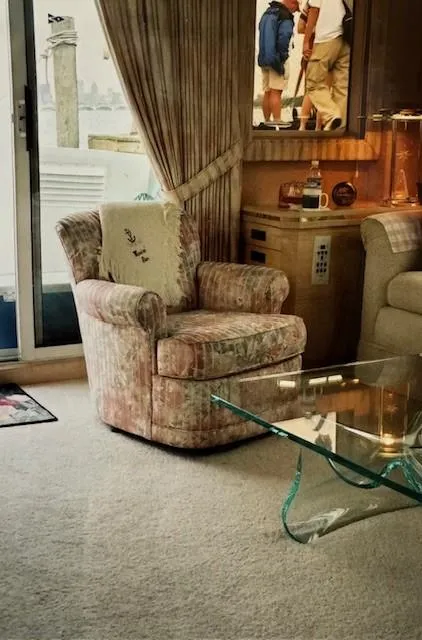 Slide: The Image of Interior of 1990 Motor Yacht 70 Brata with plush chair and glass table. - 17