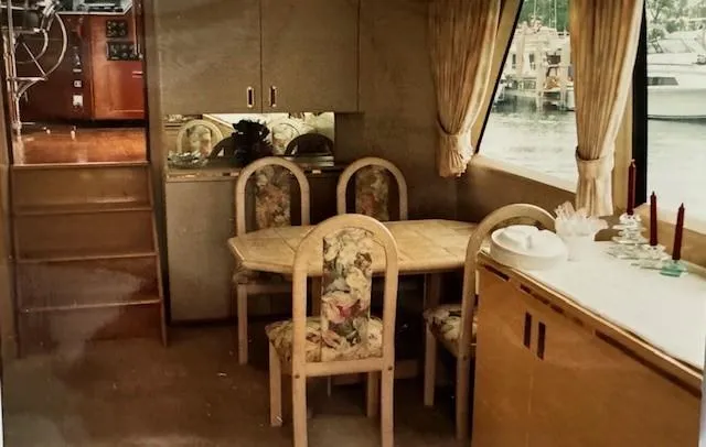 Slide: The Image of Interior of 1990 Motor Yacht 70 Brata with dining area and large window view. - 18