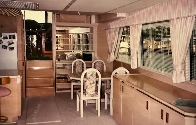 Slide: The Image of Interior of 1990 Motor Yacht 70 Brata with dining area and large windows. - 21