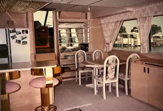 Slide: The Image of Interior of 1990 Motor Yacht 70 Brata with dining area and bar stools. - 23