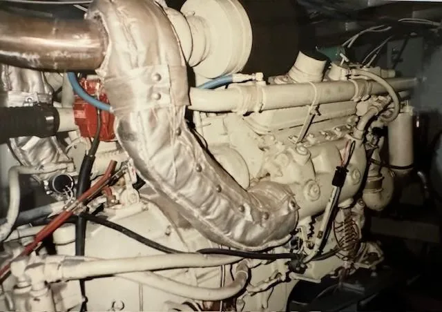 Slide: The Image of Engine room of a 1990 Motor Yacht 70 Brata, showcasing complex machinery and piping. - 29