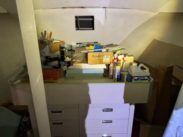 Slide: The Image of Interior storage area of a 1990 Motor Yacht 70 Brata with various supplies and tools. - 32