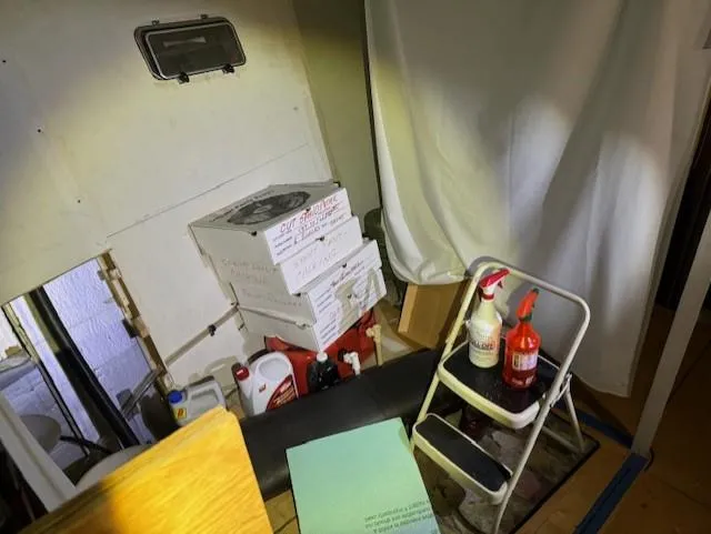 Slide: The Image of A storage area inside a 1990 Motor Yacht 70 Brata with cleaning supplies and boxes. - 35